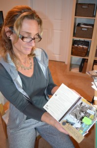 Toni Newman proudly displaying her first collage journal page.