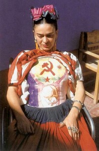 Photo of Frida wearing the body cast she painted depicting hammer, sickle and embryo.